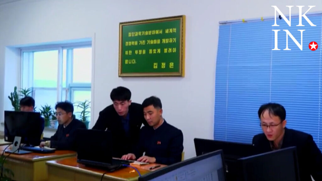 3 | nk insider four men sit at a long desk with laptops in an office a green framed plaque hangs on the wall and nkin logo appears in the top right corner