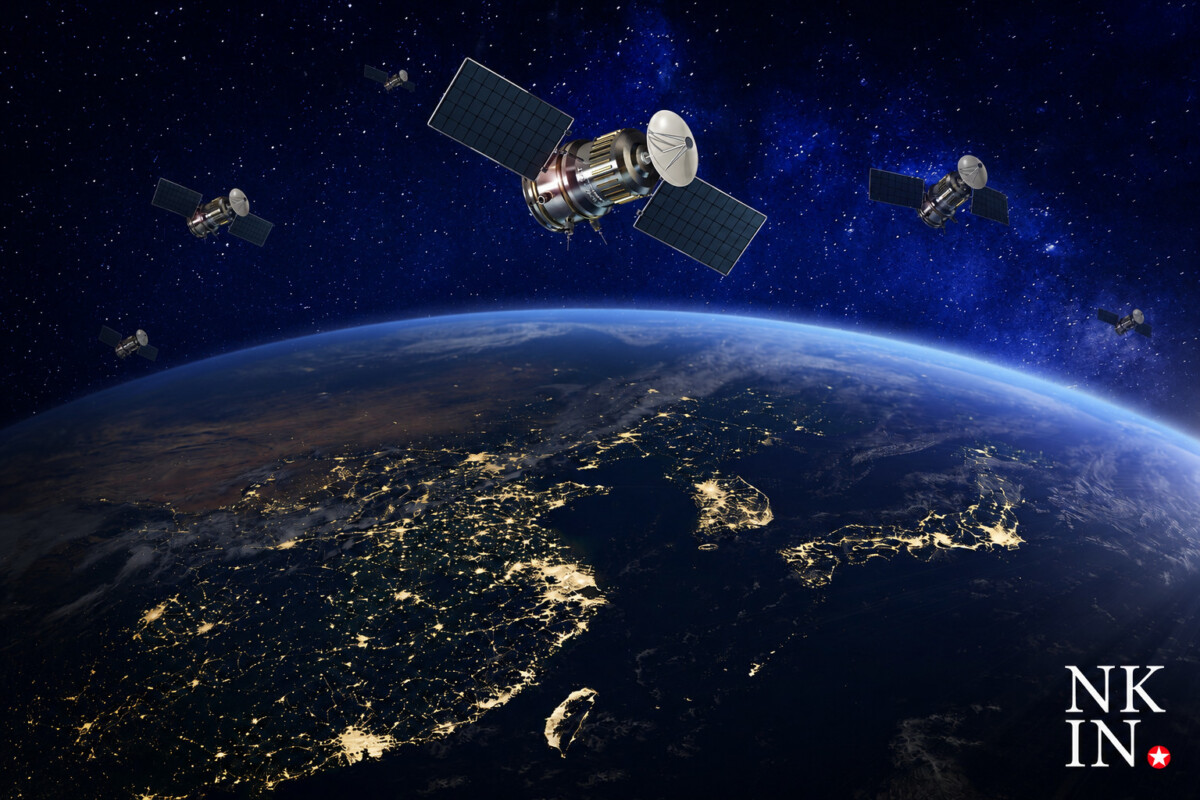 | nk insider earth viewed from space at night illuminated cities along coastlines with several satellites in orbit and a bright logo in the bottom right corner nkin