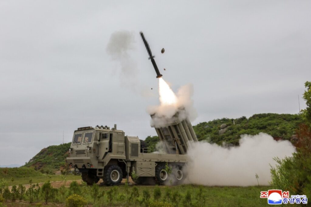 Kju at a missile test site 4 | nk insider military rocket launcher firing a rocket smoke and dust plume rising from the ground