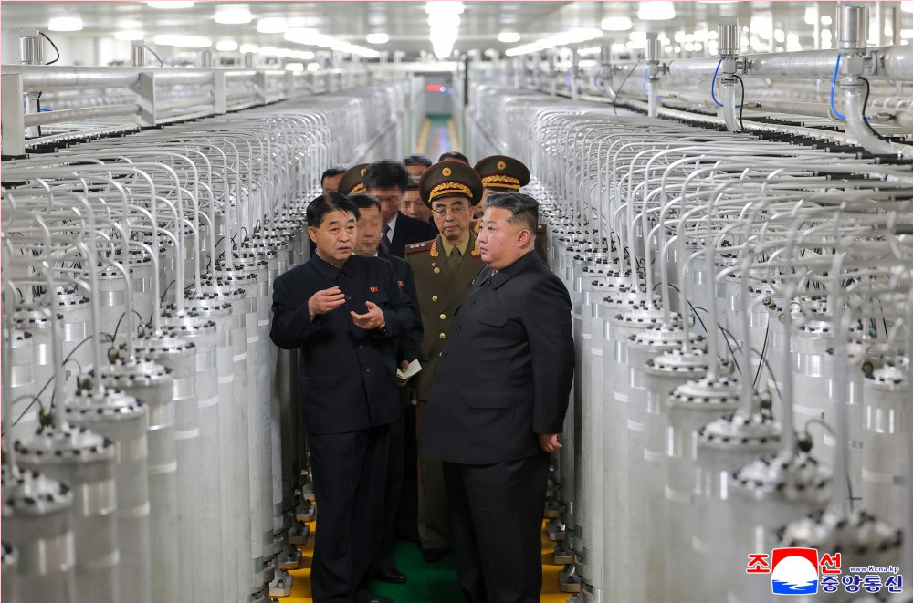 Kju visiting a nuclear facility | nk insider north korean leader kim jong un and officials tour a large textile factory with rows of knitting machines lining the production floor
