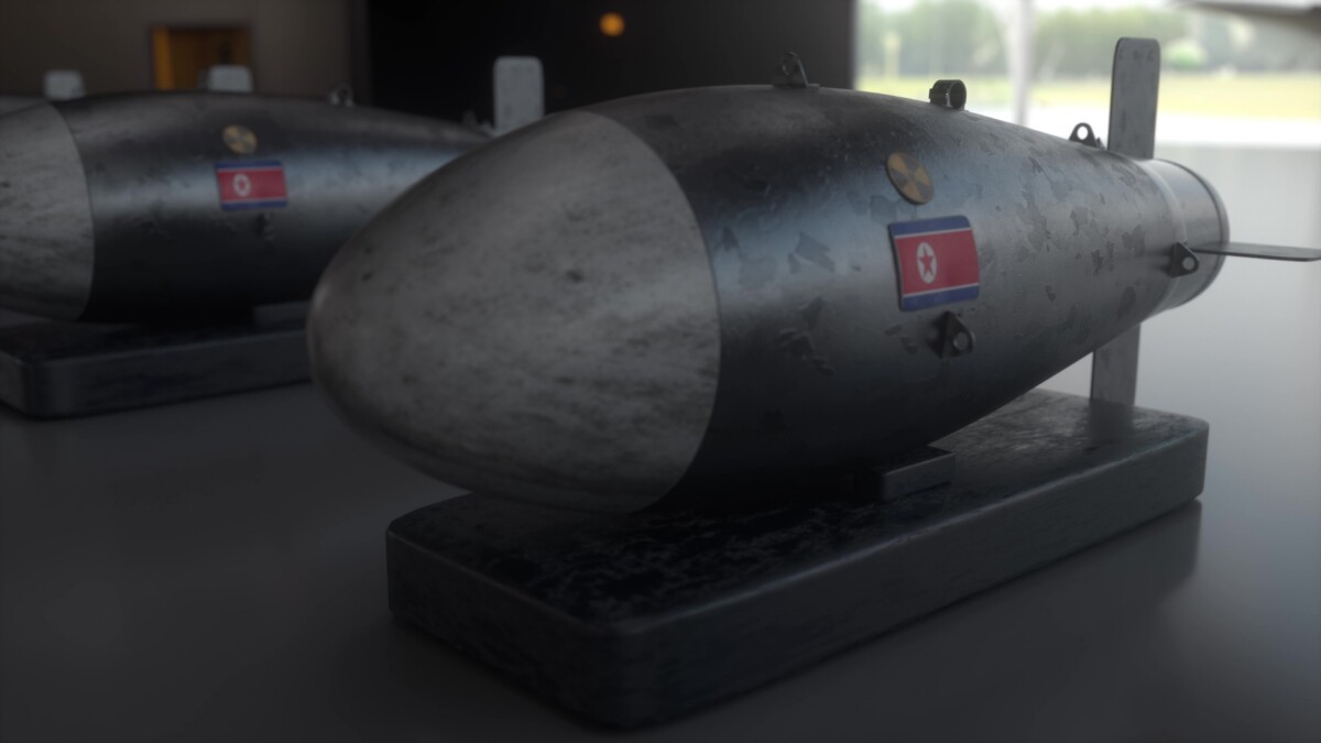 Nuclear missile with flag of north korea weapons of mass destruction nuclear chemical weapons radiation 3d illustration | nk insider two gray cylindrical bombs on dark wooden bases sit on a smooth display table in a dim room with small flag stickers on their sides