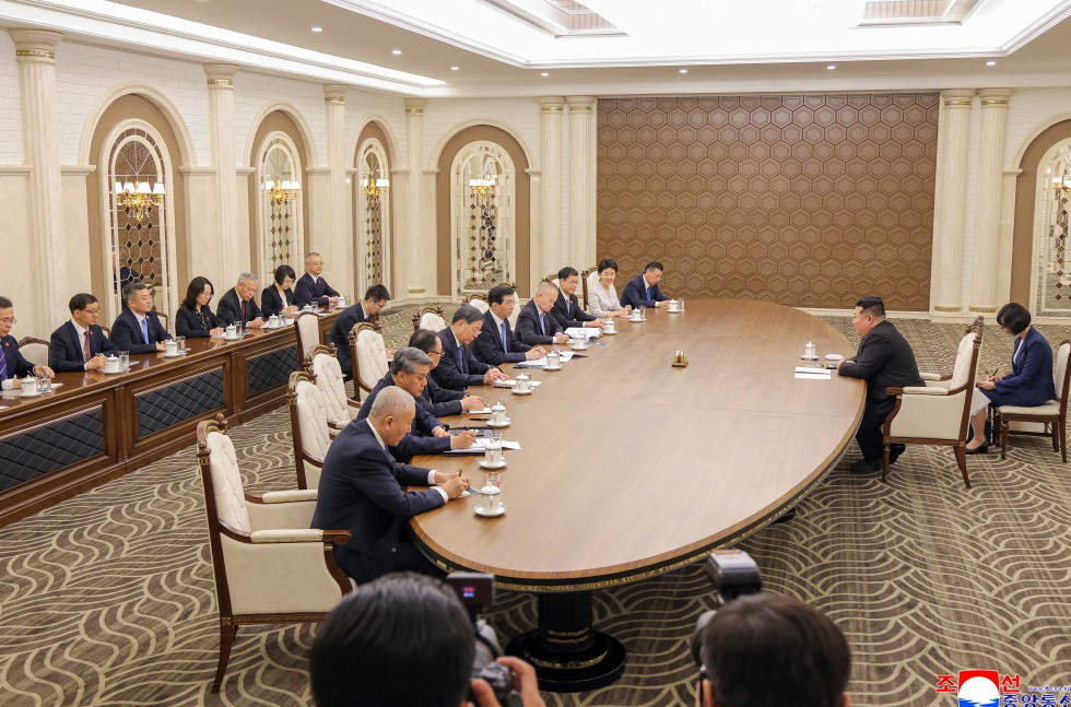 K meeting w | nk insider formal diplomatic meeting around a large oval table with officials seated on both sides in a luxurious conference room