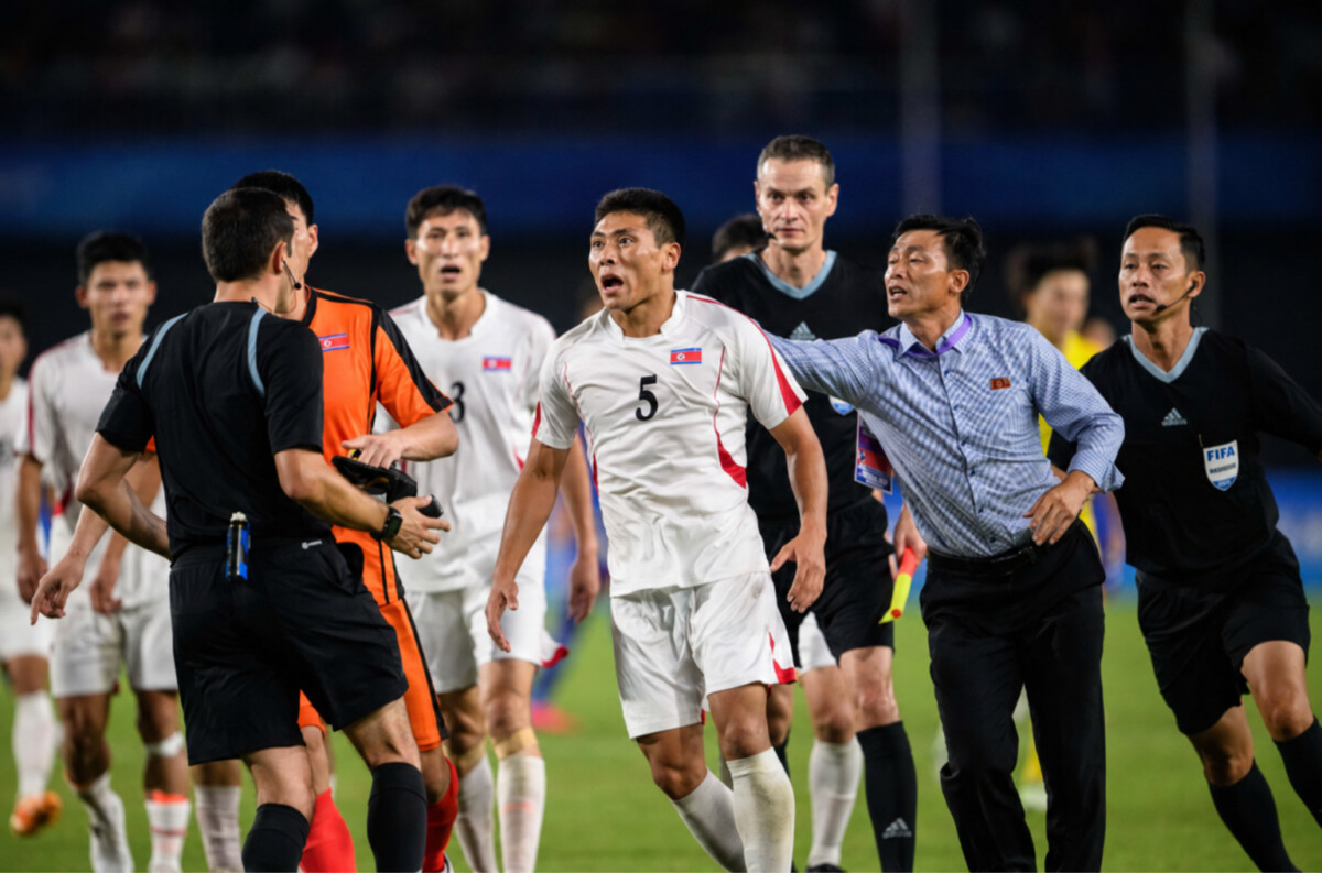 North koreas furious footballers aggressively confront referee rustam lutfullin after their asian games exit Photo courtesy of philip fongafp | nk insider north koreas furious footballers aggressively confront referee rustam lutfullin after their asian games exit photo courtesy of philip fongafp